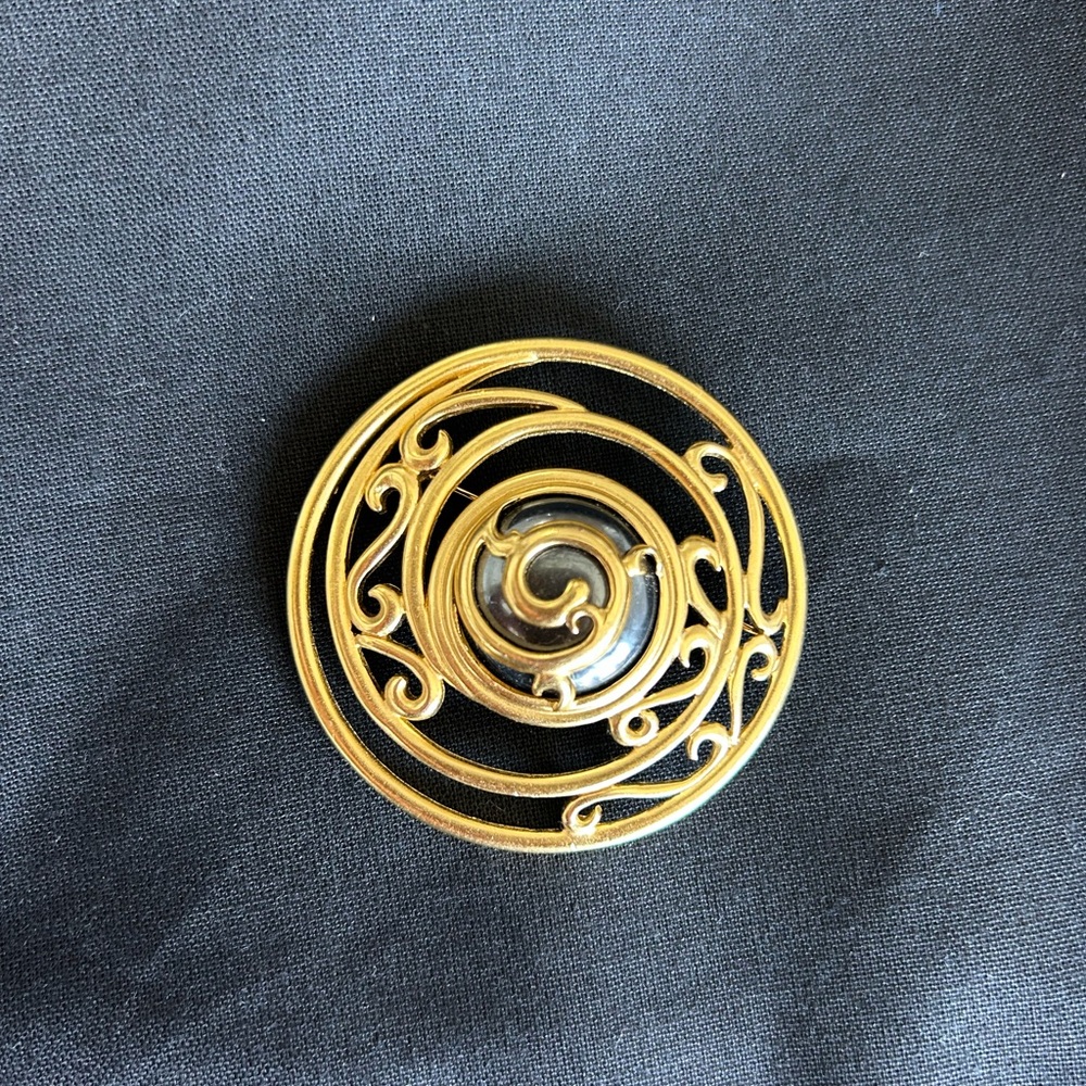 Vintage Monet Gold Spiral Brooch with Black Enamel Center